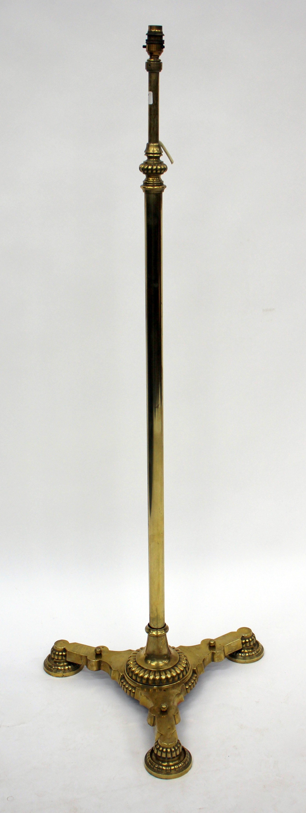 A VICTORIAN BRASS MESSENGER PATENT STANDARD LAMP with an adjustable column and a triform base, 207cm