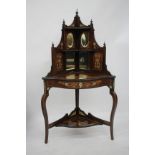 AN EDWARDIAN ROSEWOOD MIRROR BACKED CORNER DISPLAY TABLE with satinwood and ivory inlaid decoration,