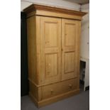 A 20TH CENTURY PINE WARDROBE with two panelled doors above one long drawer with turned knob