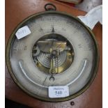 A 19TH CENTURY BRASS AND IRON ANEROID BAROMETER by J. Pyott, West India Dock Road, 20cm diameter