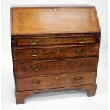 A GEORGIAN OAK BUREAU, the fall front opening to reveal pigeon holes and drawers, all above four