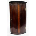 A 19TH CENTURY BOW FRONTED MAHOGANY CORNER CABINET, 75cm wide