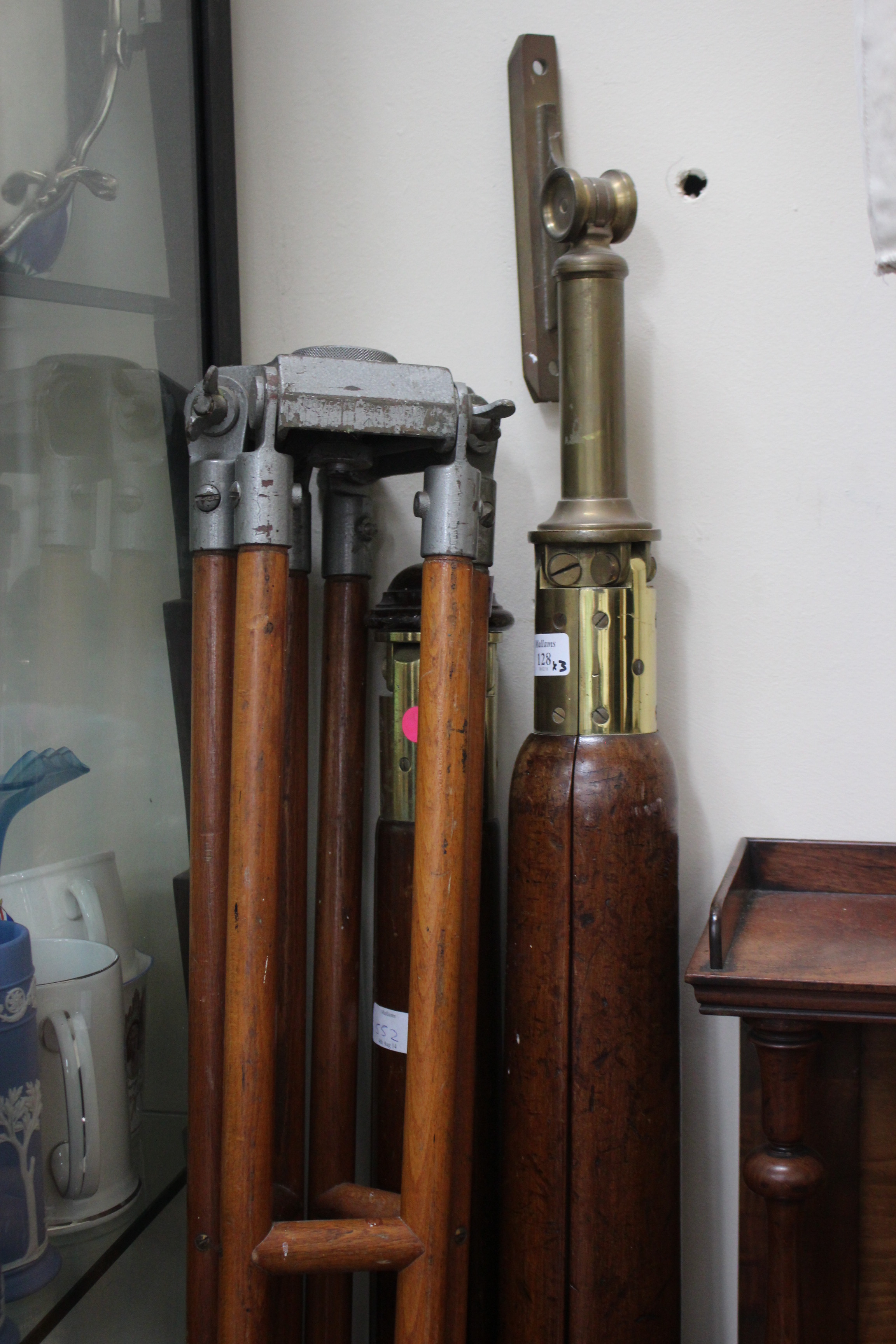 A 19TH CENTURY LARGE MAHOGANY AND BRASS TRIPOD 176cm in length, a similar tripod and an early 20th