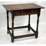 AN ANTIQUE OAK SIDE TABLE, the frieze drawer with brass drop handles and standing on turned legs