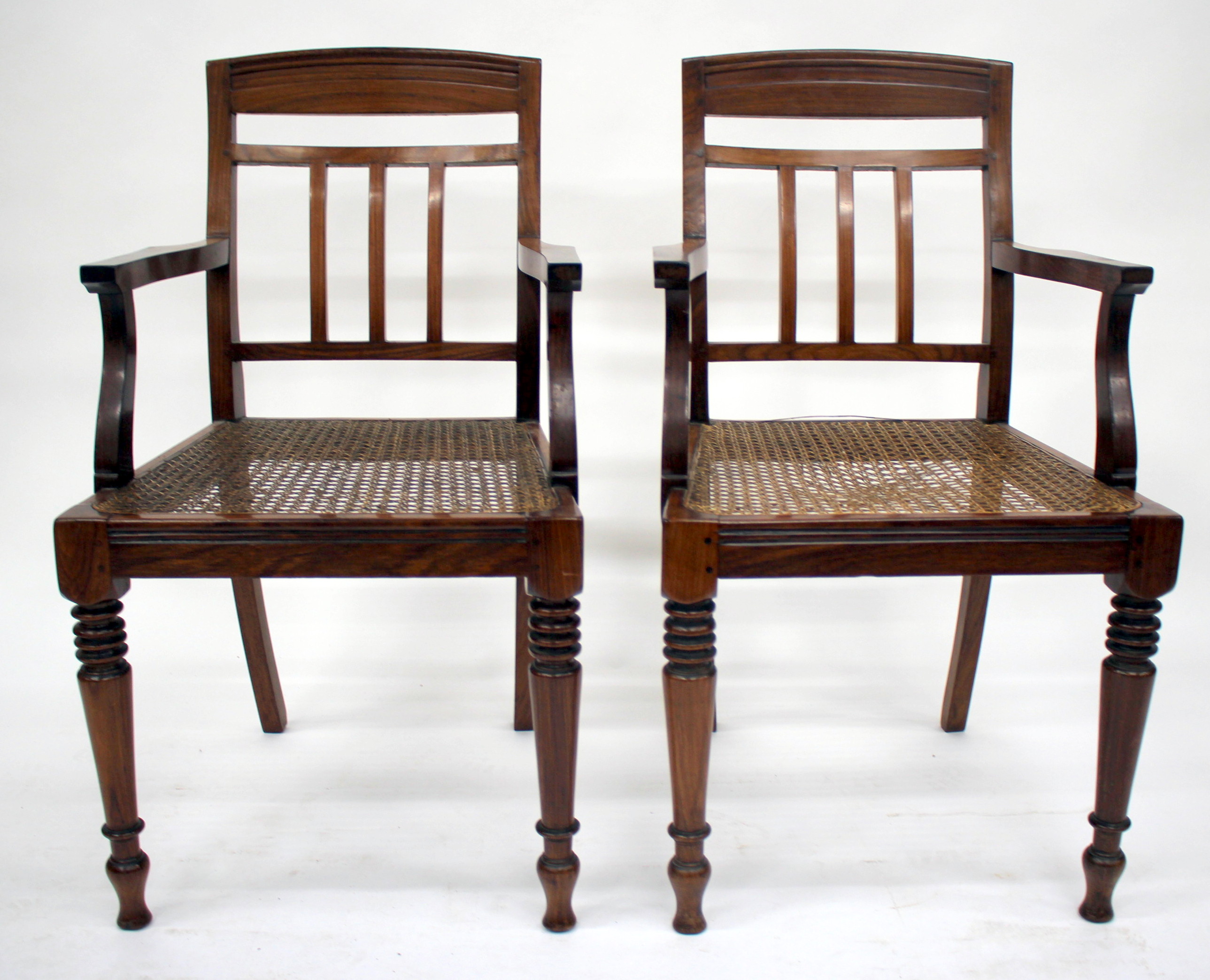 A SET OF SIX ROSEWOOD COLONIAL ARMCHAIRS with splat backs, bergere seats and turned front feet