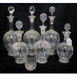 SIX 19TH CENTURY GLASS DECANTERS, each with engraved crest decoration of varying sizes, the