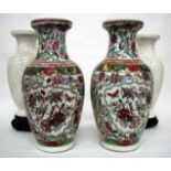 A PAIR OF CHINESE VASES of baluster form painted with birds amongst flowering branches in colours,