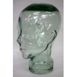 A MOULDED GREEN GLASS JAR in the form of a human head, 30cm in height
