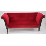 A SMALL MAHOGANY RED DRAYLON UPHOLSTERED SOFA with scroll ends and standing on turned tapering legs,