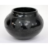A MARIE AND JULIAN BLACK BASALT GLAZED SQUAT VASE of ovoid form decorated with stylised wheat ear