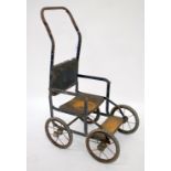 A LATE 19TH / EARLY 20TH CENTURY TIN PLATE CHILD'S CHAIR on four spoked wheels, 66cm in height