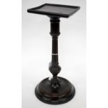 A GEORGE III MAHOGANY TAPER STICK STAND with a square top, a fluted and turned column and a weighted