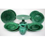 A SET OF SIX WEDGWOOD GREEN GLAZED CABBAGE MOULDED PLATES, faults; a green glazed basket weave