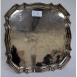 A SILVER SQUARE SALVER with serpentine pie crust edge, marks for Sheffield and makers of Walker &