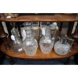 A CUT GLASS CLARET JUG with silver mounted lid 17cm high, a pair of 19th century decanters with