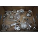 A COLLECTION OF VICTORIAN AND LATER silver topped perfume bottles and cut glass jars