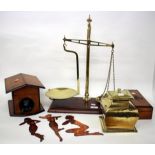 A SET OF 19TH CENTURY BRASS SCALES with a mahogany base and five Warmisham weights together with a