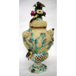 A 19TH CENTURY PORCELAIN VASE AND COVER of baluster form with all over encrusted floral and exotic