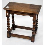 AN OLD OAK JOINT STOOL on turned tapering legs united by stretchers, 47.5cm wide