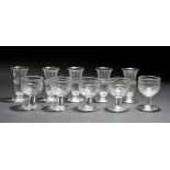 A GROUP OF FIVE CUT GLASS HEAVY SALTS 10cm high together with a set of five cut glass syllabub