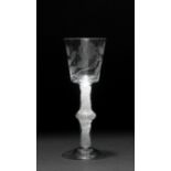 AN 18TH CENTURY CORDIAL GLASS the bucket shaped bowl engraved with a rose on a stem with central