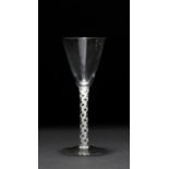 AN ANTIQUE WINE GLASS, the conical bowl above a lace twist stem and circular spreading base, the