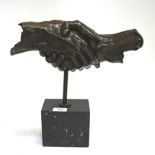 A CONTEMPORARY BRONZE SCULPTURE of hands shaking on a rectangular black marble base, overall 34cm in