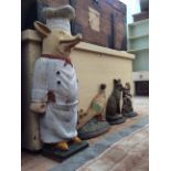 FOUR CAST IRON DOOR PORTERS, one in the form of a pig in a chefs outfit 60cm in height also a