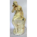 A PLASTER STATUE of a semi clad female seated figure, signed J. A. Ewing and dated 1890 to the base,