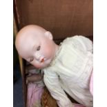 AN ANTIQUE GERMAN BISQUE HEAD DOLL 45cm in length and a further doll