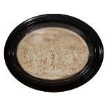 AN OVAL PLASTER THREE DIMENSIONAL PANEL depicting St John The Baptist, numerous attendant figures