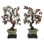 A PAIR OF MID 20TH CENTURY CHINESE HARDSTONE TREES each in rectangular jade planters with carved