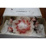 A TABLE DECORATION in the form of a flower constructed from flamingo feathers, complete with