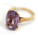 A 14 CARAT GOLD RING SET WITH AN OVAL CUT AMETHYST