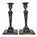 A PAIR OF VICTORIAN SILVER CANDLESTICKS of square column form with chased decoration, made by Thomas