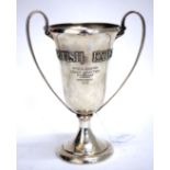 A GEORGE V SILVER TWO HANDLED TROPHY CUP of military interest with carded lettering for the