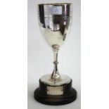 A GEORGE V SILVER TROPHY CUP the bowl with engraved flower decoration on a knopped stem and circular