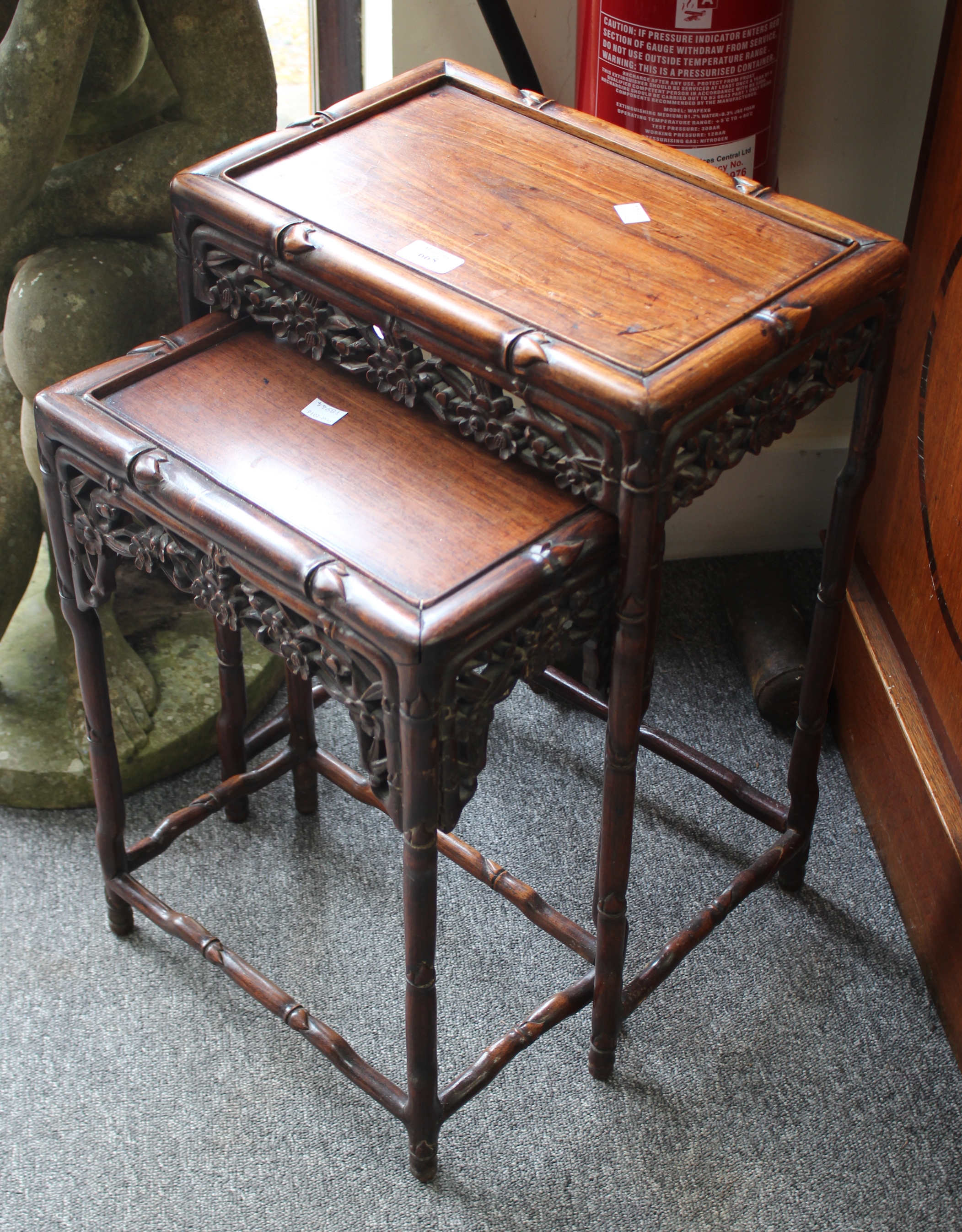 A NEST OF TWO CHINESE HARDWOOD OCCASIONAL TABLES late 19th Century, each carved with bamboo and