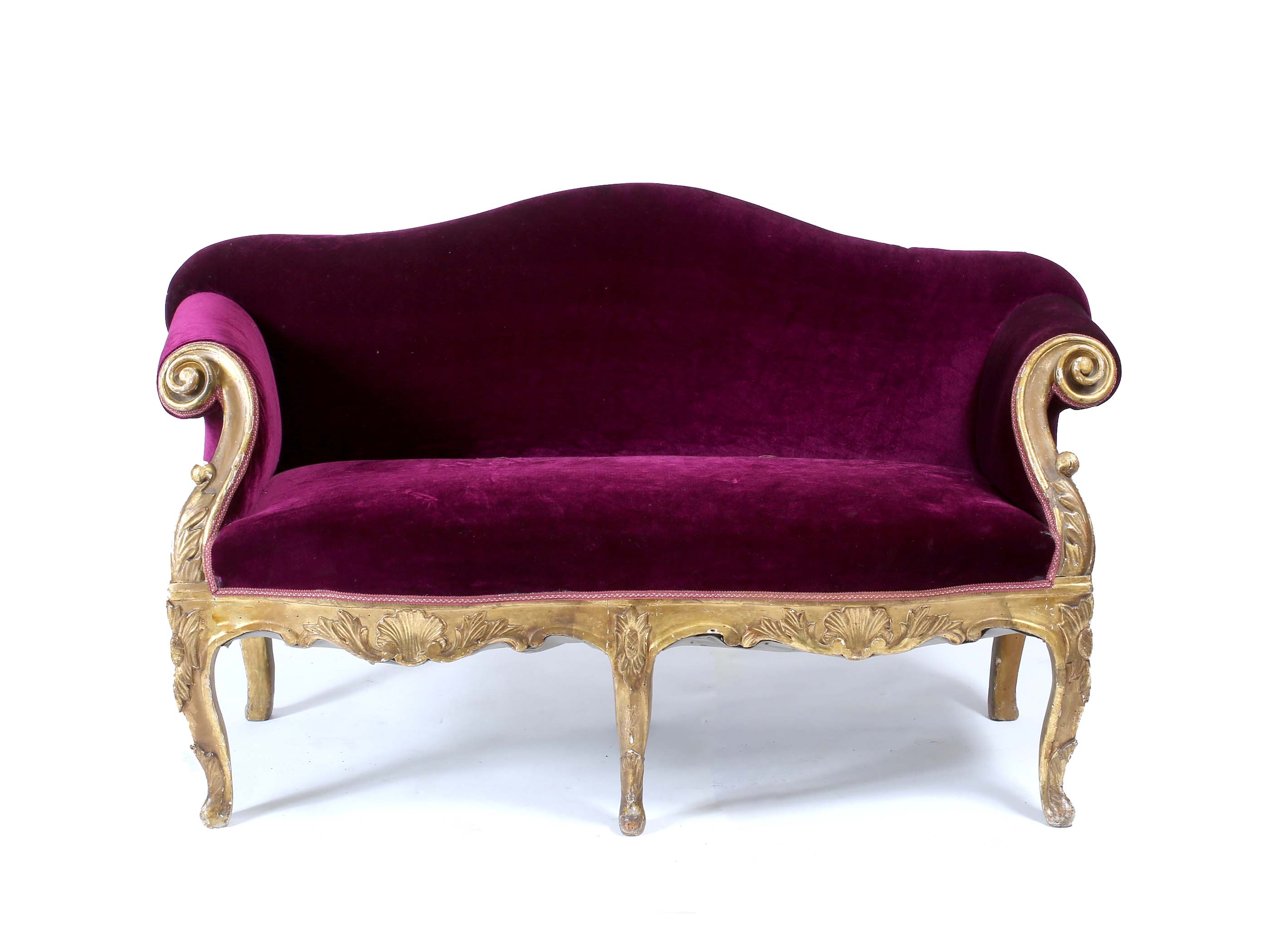 A VICTORIAN CARVED WOOD GILT FRAMED SMALL CAMEL BACK SOFA upholstered in purple material, with