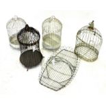 SEVEN PAINTED MODERN BIRD CAGES three cream, three white, one coral and a green painted wirework