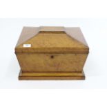 A VICTORIAN MAPLEWOOD BOX in the form of a sarcophagus with fitted interior and ring handles to