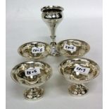 A SET OF FOUR BIRMINGHAM SILVER BOWLS on pedestal feet and a silver tapered vase with engraved