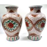 A PAIR OF PORCELAIN VASES of inverted baluster form decorated in iron red and green with