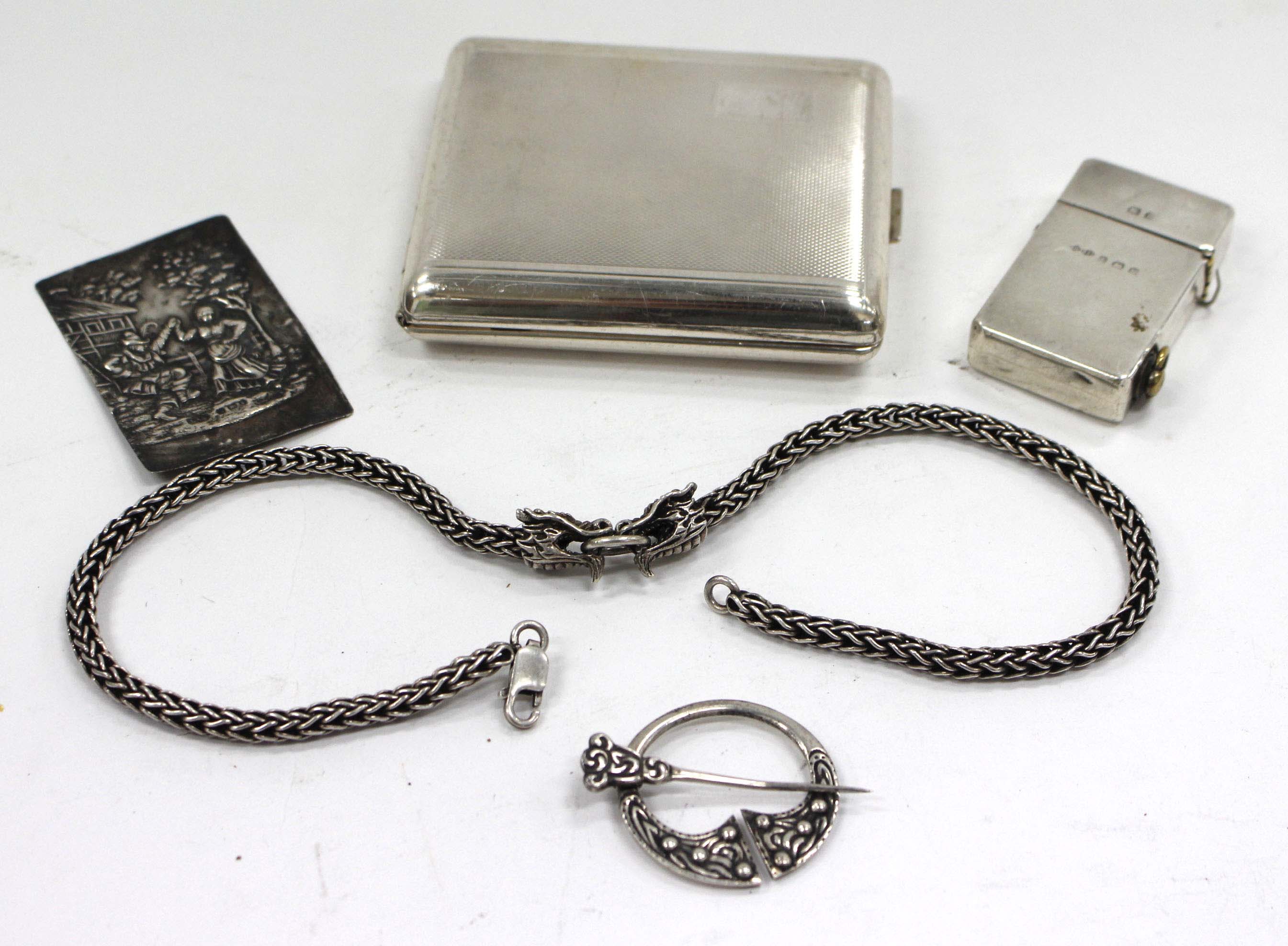A SILVER CIGARETTE CASE a silver lighter, a Scottish brooch, a white metal necklace and a silver