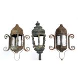 A PAIR OF PIERCED HEXAGONAL LANTERNS mounted on staffs, each lantern and bracket 57cm high