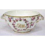 AN EARLY 19TH CENTURY PORCELAIN TWIN HANDLED FOOTED BOWL with hand painted rose decoration and