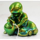 ZSOLNAY, HUNGARY, PECS GREEN LUSTRE POTTERY FIGURE of a child, 9cm wide