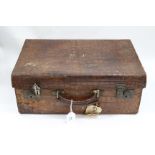 A VINTAGE CROCODILE SKIN TRAVELLING CASE with fitted leather compartments inside, lined with