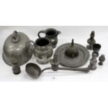 A SMALL GROUP OF PEWTER WARES consisting of a 19th century ladle, various pepper pots, a meat cover,