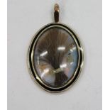 A GEORGE III MEMENTO MORI PENDANT, the oval pendant set with a small sheaf of hair and with black